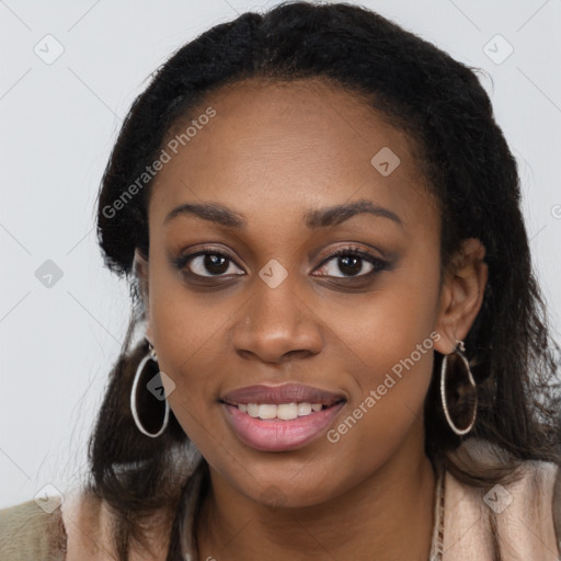 Joyful black young-adult female with long  brown hair and brown eyes