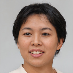 Joyful asian young-adult female with short  brown hair and brown eyes