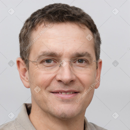 Joyful white adult male with short  brown hair and grey eyes