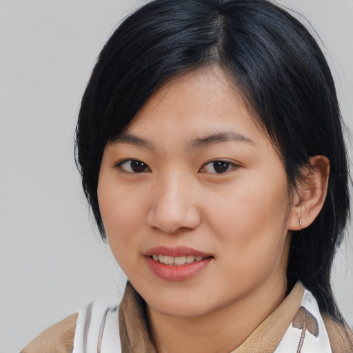 Joyful asian young-adult female with medium  black hair and brown eyes