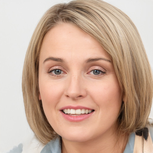 Joyful white young-adult female with medium  brown hair and blue eyes