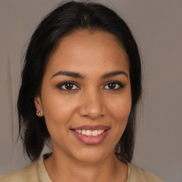 Joyful latino young-adult female with long  brown hair and brown eyes