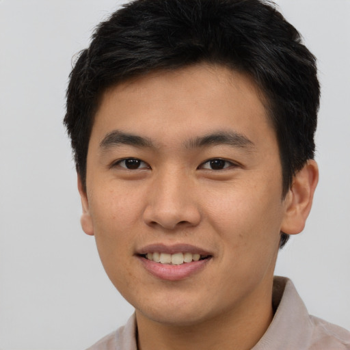 Joyful asian young-adult male with short  brown hair and brown eyes