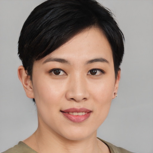 Joyful asian young-adult female with short  black hair and brown eyes