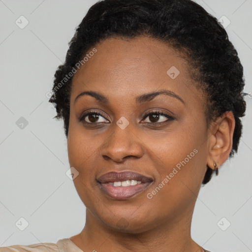 Joyful black young-adult female with short  black hair and brown eyes