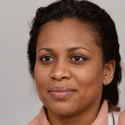 Joyful black young-adult female with medium  brown hair and brown eyes
