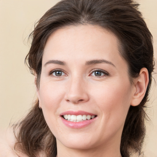 Joyful white young-adult female with medium  brown hair and brown eyes