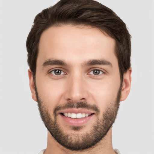 Joyful white young-adult male with short  brown hair and brown eyes