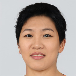 Joyful asian young-adult female with short  black hair and brown eyes