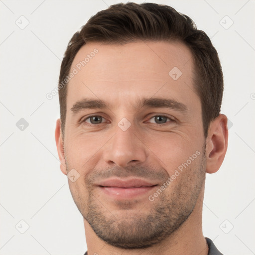 Joyful white young-adult male with short  brown hair and brown eyes