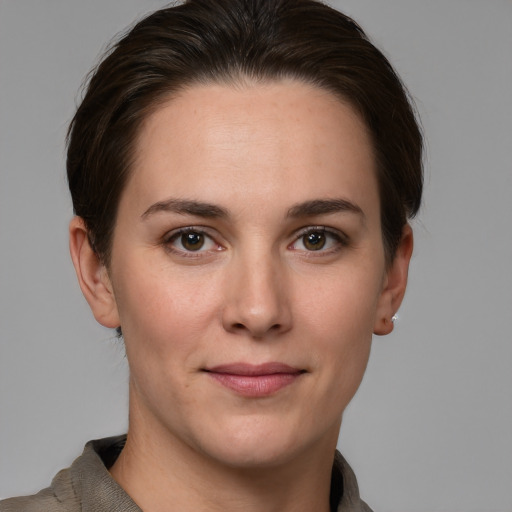 Joyful white young-adult female with short  brown hair and grey eyes