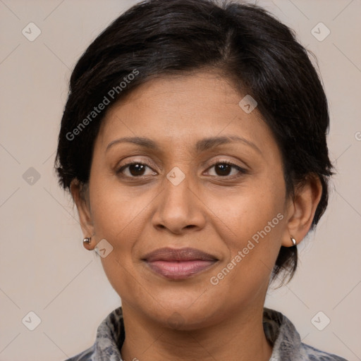 Joyful latino adult female with medium  brown hair and brown eyes