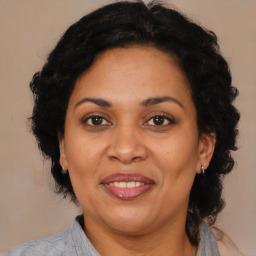 Joyful latino adult female with medium  brown hair and brown eyes