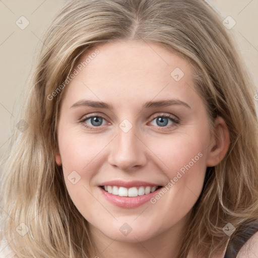 Joyful white young-adult female with long  brown hair and blue eyes