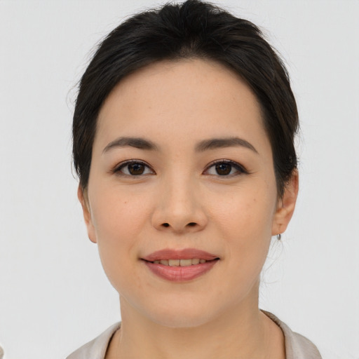 Joyful asian young-adult female with medium  brown hair and brown eyes
