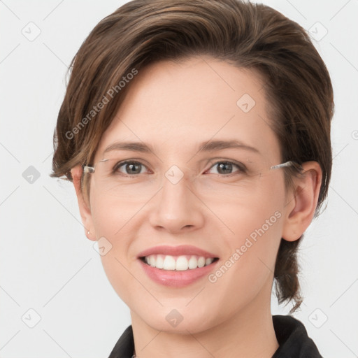 Joyful white young-adult female with medium  brown hair and grey eyes