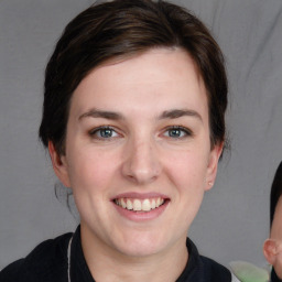 Joyful white young-adult female with medium  brown hair and grey eyes