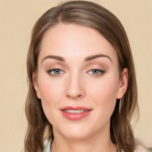 Joyful white young-adult female with long  brown hair and green eyes