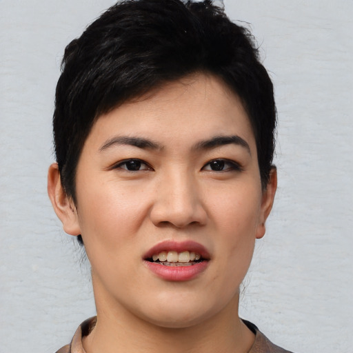 Joyful asian young-adult female with short  black hair and brown eyes