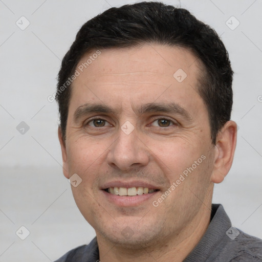 Joyful white adult male with short  brown hair and brown eyes