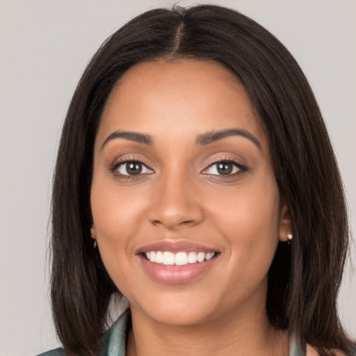 Joyful latino young-adult female with long  brown hair and brown eyes