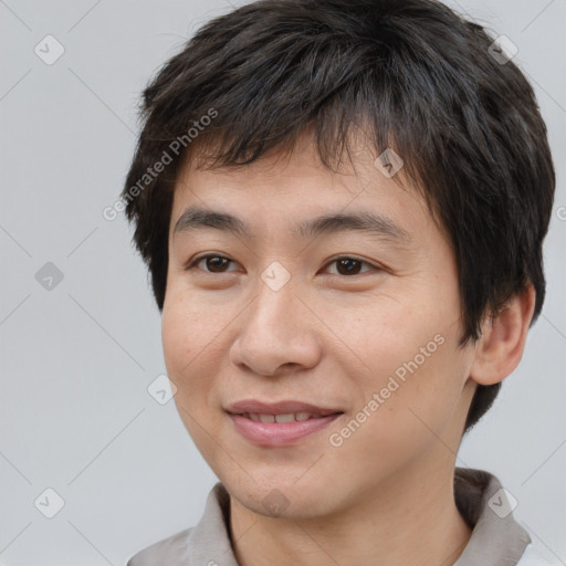 Joyful asian young-adult male with short  brown hair and brown eyes