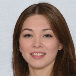 Joyful asian young-adult female with long  brown hair and brown eyes