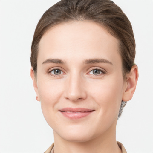 Joyful white young-adult female with long  brown hair and grey eyes