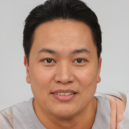 Joyful asian adult male with short  brown hair and brown eyes