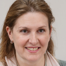 Joyful white adult female with medium  brown hair and grey eyes