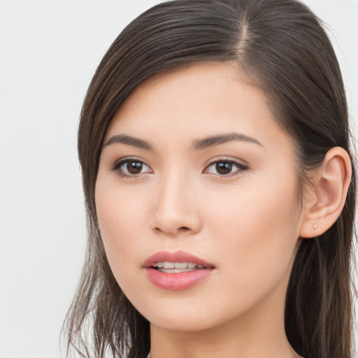 Joyful asian young-adult female with long  brown hair and brown eyes