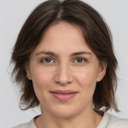 Joyful white adult female with medium  brown hair and grey eyes