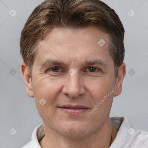 Joyful white adult male with short  brown hair and brown eyes