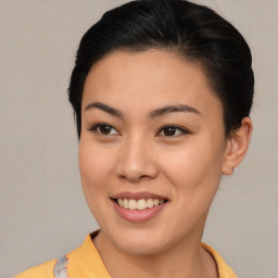 Joyful asian young-adult female with short  brown hair and brown eyes