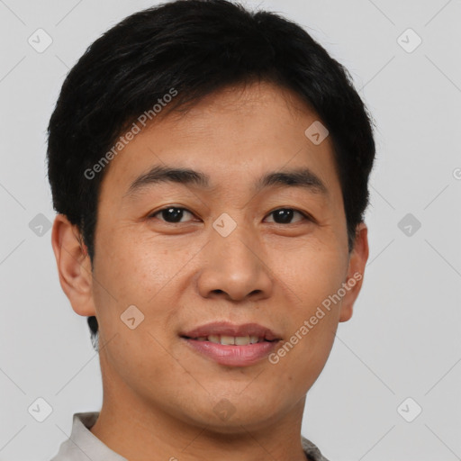 Joyful asian young-adult male with short  black hair and brown eyes