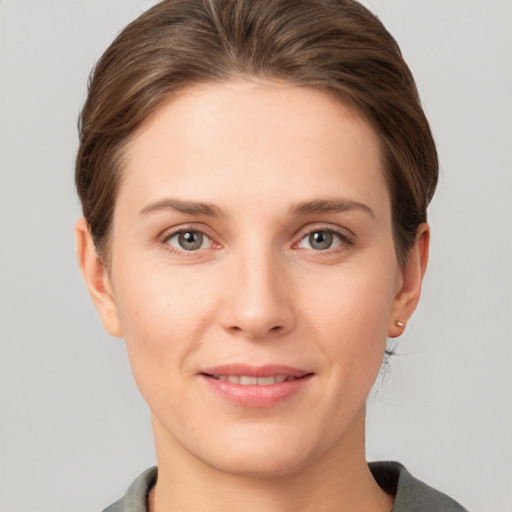 Joyful white young-adult female with short  brown hair and grey eyes