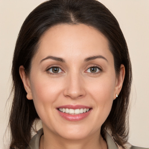 Joyful white young-adult female with medium  brown hair and brown eyes