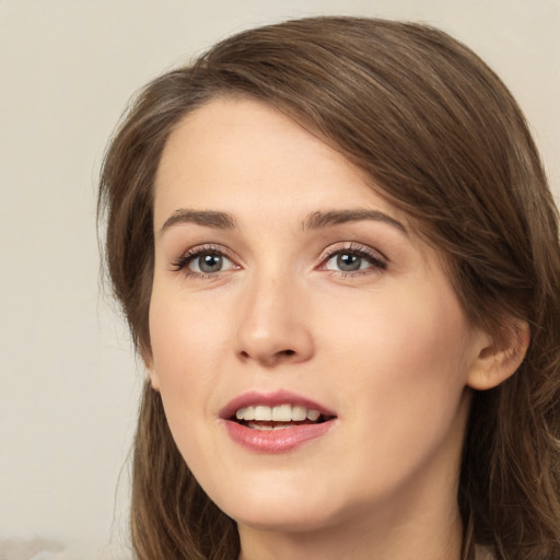 Joyful white young-adult female with medium  brown hair and green eyes