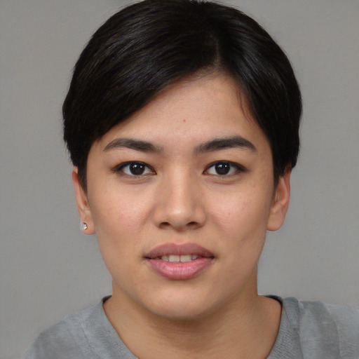 Joyful asian young-adult female with short  black hair and brown eyes