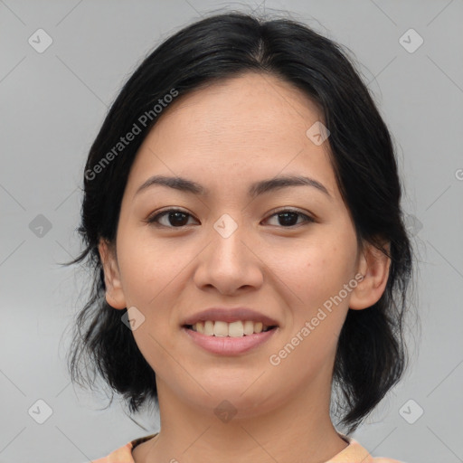 Joyful asian young-adult female with medium  black hair and brown eyes