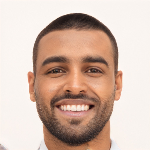 Joyful black young-adult male with short  black hair and brown eyes