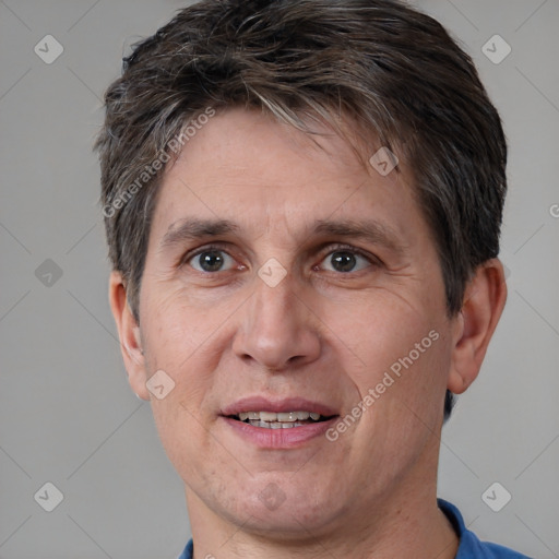 Joyful white adult male with short  brown hair and brown eyes