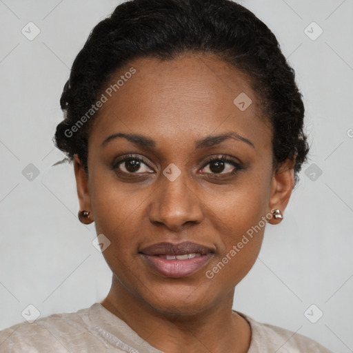 Joyful black young-adult female with short  black hair and brown eyes