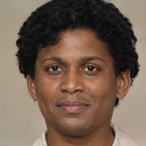 Joyful black adult male with short  brown hair and brown eyes