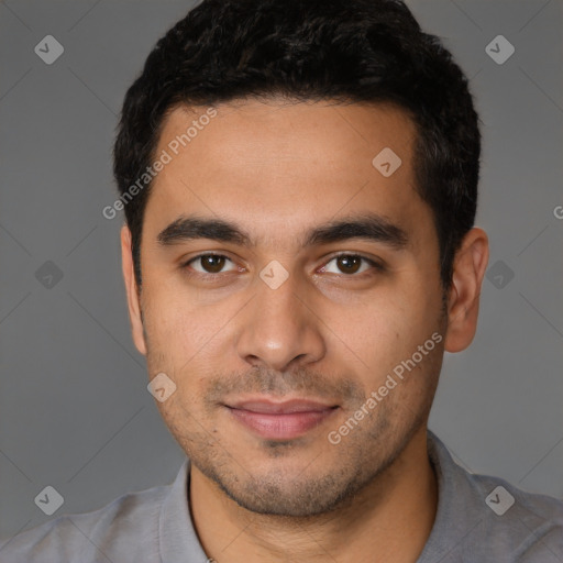 Joyful latino young-adult male with short  black hair and brown eyes