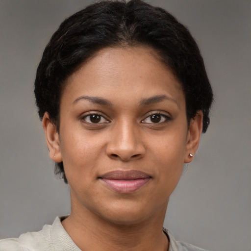 Joyful black young-adult female with short  brown hair and brown eyes