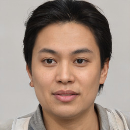 Joyful asian young-adult male with short  brown hair and brown eyes