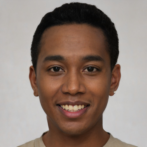 Joyful black young-adult male with short  black hair and brown eyes