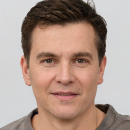 Joyful white adult male with short  brown hair and grey eyes