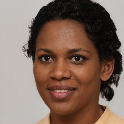 Joyful black young-adult female with medium  brown hair and brown eyes